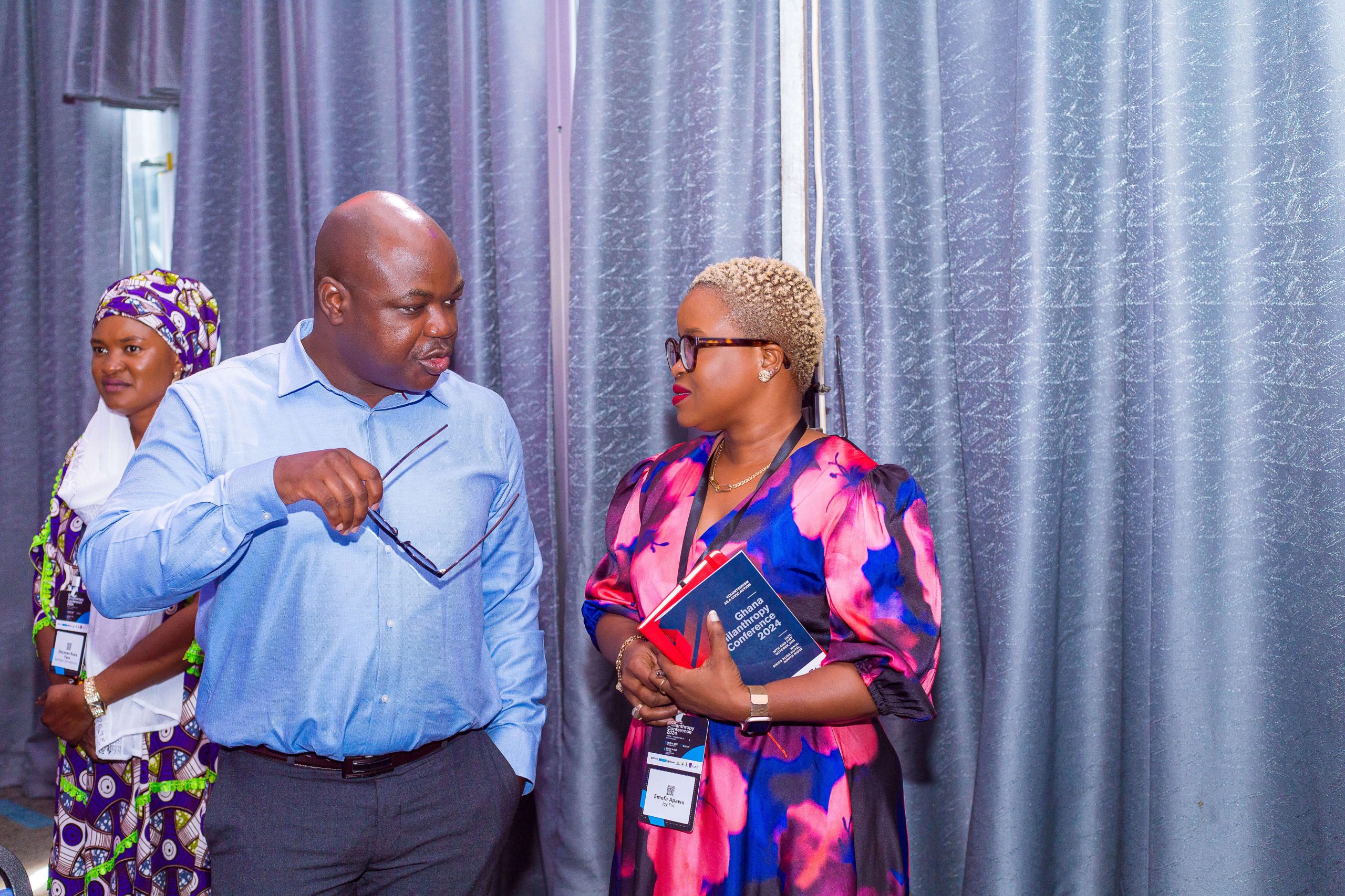 Guests with printed name tags at a conference in Ghana